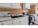 Kitchen sink with white cabinets, wood paneling, and a view of the outside at 2927 S Church St, Rocky Mount, NC 27803