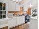 Cozy kitchen features white cabinetry, laminate counters, and wood paneling at 2927 S Church St, Rocky Mount, NC 27803
