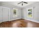 Bright living room featuring hardwood floors, a ceiling fan, and large windows at 2927 S Church St, Rocky Mount, NC 27803