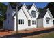 New construction two-story white brick home with a dark roof and many windows at 3004 William Frederick Way, Raleigh, NC 27603