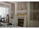 Unfinished living room showcasing fireplace with custom trim, built-in cabinets, and a cozy atmosphere during renovations at 3004 William Frederick Way, Raleigh, NC 27603