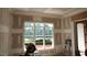Bright, unfinished living room showcasing a large window and stylish trim during renovations at 3004 William Frederick Way, Raleigh, NC 27603