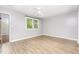 A serene bedroom with hardwood floors, a ceiling fan, and a window for natural light at 303 Applecross Dr, Cary, NC 27511
