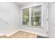 Entryway view featuring hardwood floors, a window with blinds, and a white painted door at 303 Applecross Dr, Cary, NC 27511