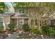 Charming home featuring a well-maintained exterior, lush landscaping, and a welcoming entrance adorned with potted flowers at 303 Applecross Dr, Cary, NC 27511