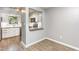 Kitchen view with white cabinets, stainless appliances, granite countertops, and hardwood floors at 303 Applecross Dr, Cary, NC 27511