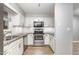 Charming kitchen featuring white cabinets, stainless steel appliances, and granite countertops at 303 Applecross Dr, Cary, NC 27511