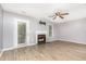 Spacious living room with hardwood floors, neutral walls, fireplace, ceiling fan, and natural light at 303 Applecross Dr, Cary, NC 27511