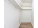 Spacious walk-in closet with wooden floor and white shelves ready to be filled at 303 Applecross Dr, Cary, NC 27511