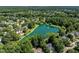 Aerial view of a community lake surrounded by trees and homes at 318 Riggsbee Farm Dr, Cary, NC 27519