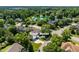 Aerial view of a neighborhood with mature trees and a community lake at 318 Riggsbee Farm Dr, Cary, NC 27519