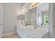 Elegant bathroom with double vanity, tiled floor, large mirror, and a soaking tub next to the window at 318 Riggsbee Farm Dr, Cary, NC 27519