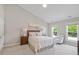 Comfortable bedroom with plush carpeting, and two windows offering natural light and views of the surrounding area at 318 Riggsbee Farm Dr, Cary, NC 27519