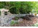 Stone community sign and entrance with statue and beautiful landscaping at 318 Riggsbee Farm Dr, Cary, NC 27519