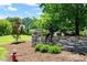 Community monument with stone wall, statue, and landscaped grounds, showcasing the neighborhood's charm at 318 Riggsbee Farm Dr, Cary, NC 27519