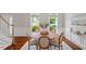 Bright dining room with hardwood floors, wainscoting, and abundant natural light for delightful meals at 318 Riggsbee Farm Dr, Cary, NC 27519