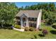 Two-story brick home with a manicured front yard and a view of the community playground at 318 Riggsbee Farm Dr, Cary, NC 27519
