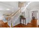 Inviting foyer with hardwood floors, staircase, and elegant decor that creates a warm ambiance at 318 Riggsbee Farm Dr, Cary, NC 27519