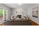 Bright living room featuring a fireplace, hardwood floors, and large window with a view of the backyard at 318 Riggsbee Farm Dr, Cary, NC 27519
