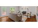 Open-concept living room boasts a fireplace, hardwood floors, and access to an outdoor deck through glass door at 318 Riggsbee Farm Dr, Cary, NC 27519