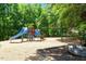 Community playground with a slide, monkey bars, and a safe, wood-chip ground cover at 318 Riggsbee Farm Dr, Cary, NC 27519