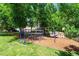 Playground set sits in the backyard among the surrounding greenery at 318 Riggsbee Farm Dr, Cary, NC 27519