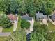 Drone shot of the home showing its surrounding lush trees and neighborhood streets at 3421 Tunas St, Raleigh, NC 27616