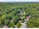High-angle aerial shot of a neighborhood with homes surrounded by dense trees at 3421 Tunas St, Raleigh, NC 27616