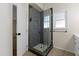 Bathroom featuring a black framed glass walk-in shower with white and black patterned floor tiles at 3421 Tunas St, Raleigh, NC 27616