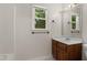 Bathroom featuring a vanity with a wooden base cabinet and a framed mirror at 3421 Tunas St, Raleigh, NC 27616