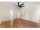 Bright bedroom with hardwood floors, ceiling fan, and two doors - one to the bathroom at 3421 Tunas St, Raleigh, NC 27616