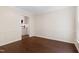 Bright dining room with hardwood floors, light walls, and a view of the kitchen at 3421 Tunas St, Raleigh, NC 27616