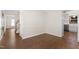Open dining area with hardwood floors, neutral paint, and views of the staircase and kitchen at 3421 Tunas St, Raleigh, NC 27616
