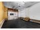 Inside of the garage with black rubber flooring, a white garage door, and an exit door at 3421 Tunas St, Raleigh, NC 27616