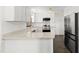 Modern kitchen with white cabinets, stainless steel appliances, and marble countertops at 3421 Tunas St, Raleigh, NC 27616