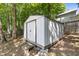 View of the home's backyard shed, with mature trees in the background at 3421 Tunas St, Raleigh, NC 27616