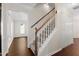 Bright foyer with a carpeted staircase, hardwood floors, and ample closet space at 3421 Tunas St, Raleigh, NC 27616