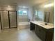 Luxurious bathroom features a soaking tub, glass-enclosed shower, and double vanity at 3509 Bailey Lake Dr, Fuquay Varina, NC 27526