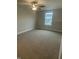 Large bedroom with neutral carpet, a window, and a ceiling fan at 3509 Bailey Lake Dr, Fuquay Varina, NC 27526