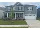 Charming two-story home with gray siding, a well-manicured lawn, and a two-car garage at 3509 Bailey Lake Dr, Fuquay Varina, NC 27526
