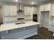 Bright kitchen featuring white cabinets, stainless steel appliances, and a spacious center island at 3509 Bailey Lake Dr, Fuquay Varina, NC 27526