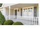 Inviting front porch featuring white railings, gray shutters, and a well-lit entryway at 3782 Loblolly Dr # 5, Rocky Mount, NC 27804