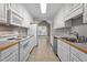 Bright kitchen featuring white cabinets, appliances, and view of a dining area at 3782 Loblolly Dr # 5, Rocky Mount, NC 27804