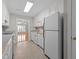 Functional kitchen with white appliances, cabinets, and view to living room at 3782 Loblolly Dr # 5, Rocky Mount, NC 27804