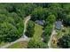 Aerial view showcasing the home and its wooded surroundings at 40 Raccoon Xing, Henderson, NC 27537