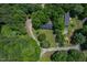 An aerial view of the house on a large wooded lot at 40 Raccoon Xing, Henderson, NC 27537