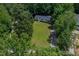 Aerial view of house surrounded by trees and green lawns at 40 Raccoon Xing, Henderson, NC 27537