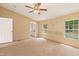 Bedroom features a door, two windows, and neutral carpet at 40 Raccoon Xing, Henderson, NC 27537