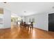 Bright dining room with laminate flooring and a view to the kitchen and front door at 40 Raccoon Xing, Henderson, NC 27537
