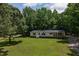 Charming home features a sprawling lawn with mature trees and a welcoming front porch at 40 Raccoon Xing, Henderson, NC 27537